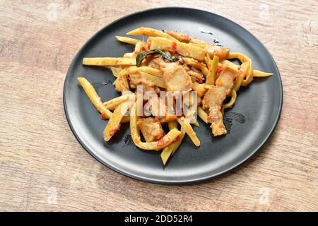 spicy stir fried bamboo shoot with crispy pork curry on plate Stock Photo