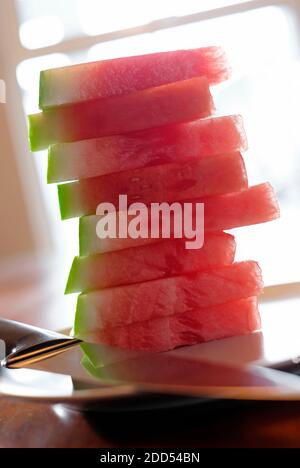 watermelon sliced segments on plate in home interior Stock Photo