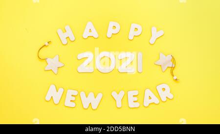 Text Happy 2021 Year made from wooden letters on yellow background Stock Photo