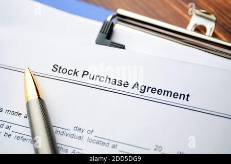 The document Stock Purchase Agreement is ready for signing. Stock Photo
