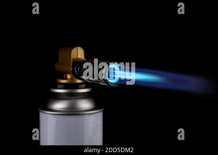 Flamethrower burner gas blow torch Ignition with blue fire flame at black background Stock Photo