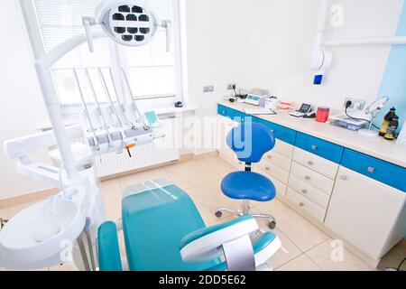 Professional Dentist tools and chair in the dental office. Dental Hygiene and Health conceptual image. Stock Photo