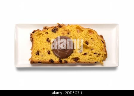 Slice of panettone with chocolate cream on rectangular white plate in top view, typical Italian dessert for Christmas from Milan, isolated on white ba Stock Photo