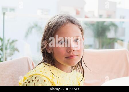 Blond little girl in yellow dress, close-up outdoor face portrait Stock Photo