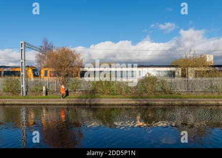 Woman walking along the towpath on the Birmingham Canal Old Line in Ladywood close to Birmingham city centre Stock Photo