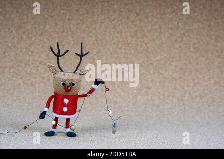 Small corkwood reindeer Christmas figure in front of corkwood background Stock Photo