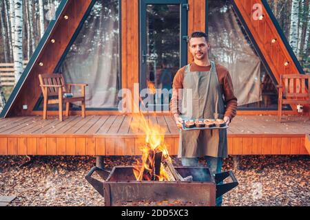 Happy man in autumn grilled Stock Photo