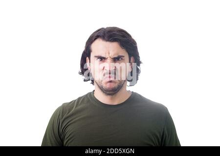 Bewildered and confused young man looking perplexed and upset to camera isolated on white background. Angry casual guy, long curly hair style, irritat Stock Photo