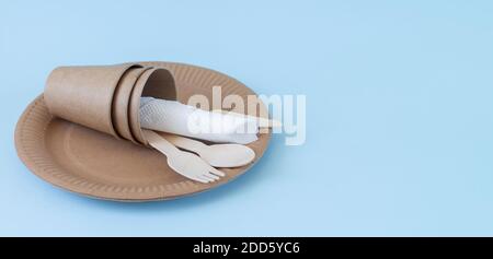 Disposable eco friendly utensils made of bamboo wood and paper on blue background Stock Photo