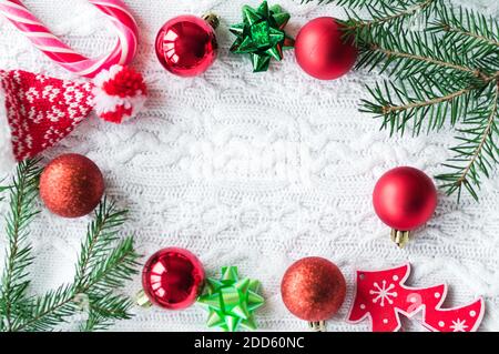 New year frame mockup. Pine cones, fir branches and Christmas balls on white knit background. Flat lay, top view with copy space Stock Photo