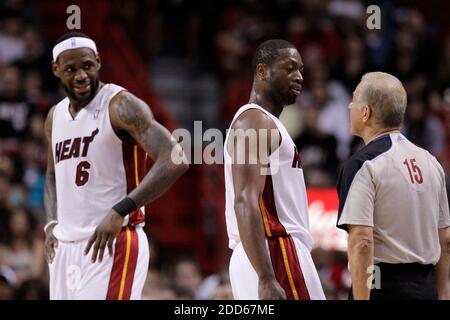 NO FILM, NO VIDEO, NO TV, NO DOCUMENTARY - The Miami Heat's Dwyane Wade, with help from teammate LeBron James (6), questions a call by official Bennett Salvatore, right, in the second period during a NBA basketball match Denver Nuggets vs Miami Heat at the American Airlines Arena in Miami, FL, USA on March 19, 2011. Miami topped Denver, 103-98. Photo by Al Diaz/Miami Herald/MCT/ABACAPRESS.COM Stock Photo