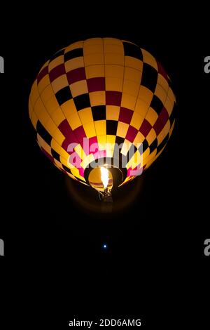 Hot air balloon flying during Dawn Patrol, Albuquerque International Balloon Fiesta, Albuquerque, New Mexico USA Stock Photo