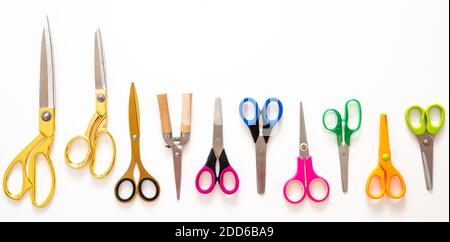Scissors set on white background, Kids school or office supplies, tailor, barber equipment, top view. Colorful handles instruments banner Stock Photo
