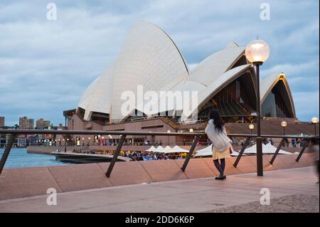 Tourist Admiring Sydney Opera House at Night, Sydney, Australia Stock Photo