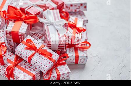 Various pattern and size Christmas boxes placed on white background. Wrapped in festive paper Stock Photo