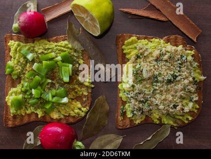 avocado toast with lemon on wooden table close up with cinnamon sticks Stock Photo