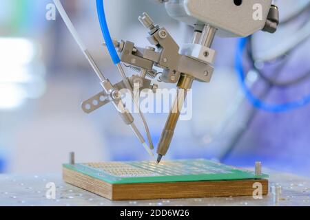 Process of selective soldering components to printed circuit board at factory Stock Photo