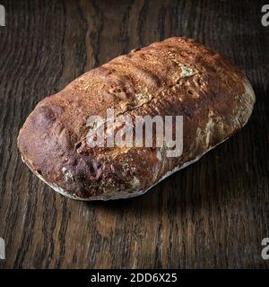 freshly baked bread on wooden table Stock Photo