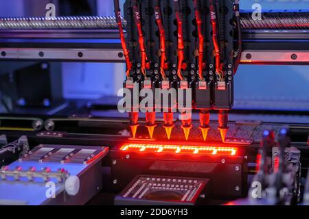 Automatic SMD pick and place machine assembling computer circuit board Stock Photo