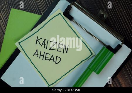 Kaizen Ahead write on sticky notes isolated on Wooden Table. Stock Photo