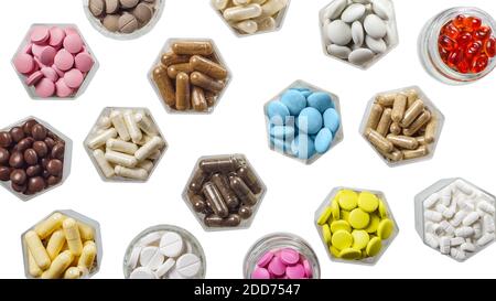 Various medical capsules and pills in hexagonal jars isolated on white Stock Photo