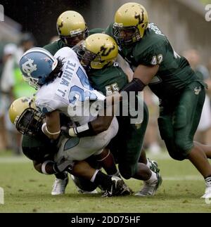 NO FILM, NO VIDEO, NO TV, NO DOCUMENTARY - North Carolina tailback Johnny White (34) is stopped for a loss of three yards by South Florida's Terrell McClain (97), Jeremiah Warren (55) and Marvin Peoples (42) during the fourth quarter at Raymond James Stadium in Tampa, FL, USA on September 22, 2007. The Bulls defeated the Tar Heels 37-10. Photo by Robert Willett/Raleigh News & Observer/MCT/CAMELEON/ABACAPRESS.COM Stock Photo