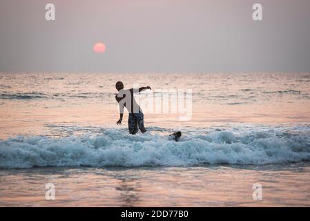 Surfing at sunset at Paradise Beach (Sar Sar Aw Beach), Dawei Peninsula, Tanintharyi Region, Myanmar (Burma) Stock Photo