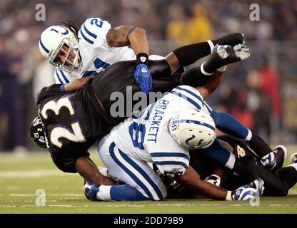 Indianapolis Colts Bob Sanders kisses the Vince Lombardi trophy as coach  Tony Dungy, his wife and Peyton Manning look on at Super Bowl XLI at  Dolphin Stadium in Miami on February 4