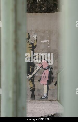 NO FILM, NO VIDEO, NO TV, NO DOCUMENTARY - Wall art in Bethlehem by British graffiti artist Banksy shows a young girl frisking a soldier. The work, photographed on Wednesday, Dec. 5, 2007, is part of 'Santa's Ghetto,' a Christmas-time project meant to draw attention to the impact of Israel's separation barrier on life for Palestinians in the West Bank. Photo by Dion Nissenbaum/MCT/ABACAPRESS.COM Stock Photo