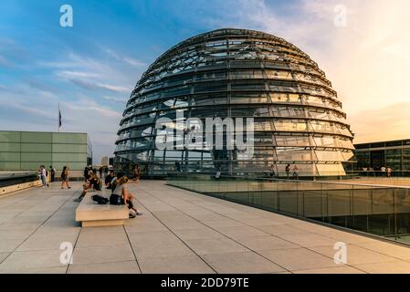 Berlin, Germany - July 28, 2019: View of the dome of Reichstag building, seat of the German Parliament. View at sunset with people enjoying the views Stock Photo