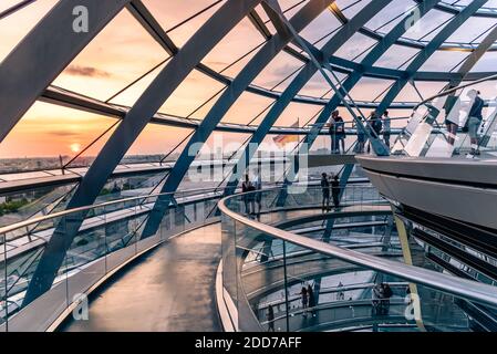 Berlin, Germany - July 28, 2019: Interior view of the helicoidal ramp under the dome of Reichstag building, seat of the German Parliament. View at sun Stock Photo