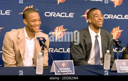 Golden State Warriors draft picks Moses Moody, left, Jonathan Kuminga,  right, pose with general manager Bob Myers, center, and hold up their new  jerseys during a news conference in San Francisco on