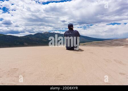 Man looks over National Sand Dunes Park Stock Photo