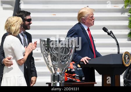 U.S. President Donald Trump speaks about 2017 Monster Energy NASCAR Cup Series champion Martin Truex Jr., while flanked by his girlfriend Sherry Pollex, on the South Lawn of the White House on May 21, 2018 in Washington, DC. Photo by Olivier Douliery/ Abaca Press Stock Photo