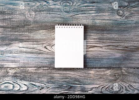 Notepad on a natural gray-blue wooden background. Stock Photo