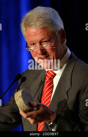 NO FILM, NO VIDEO, NO TV, NO DOCUMENTARY - UN's Special Envoy to Haiti, former US President Bill Clinton holds a brickette that sells for one penny in Haiti that can be used for cooking instead of charcoal, at the Americas Conference in Coral Gables, Florida, USA on Tuesday, September 29, 2009. Photo by Al Diaz/Miami Herald/MCT/ABACAPRESS.COM Stock Photo