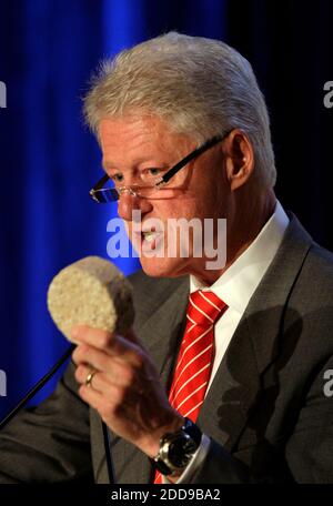 NO FILM, NO VIDEO, NO TV, NO DOCUMENTARY - UN's Special Envoy to Haiti, former US President Bill Clinton holds a brickette that sells for one penny in Haiti that can be used for cooking instead of charcoal, at the Americas Conference in Coral Gables, Florida, USA on Tuesday, September 29, 2009. Photo by Al Diaz/Miami Herald/MCT/ABACAPRESS.COM Stock Photo