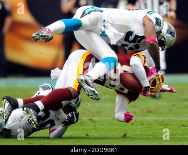 NO FILM, NO VIDEO, NO TV, NO DOCUMENTARY - Washington Redskins' Santana Moss (89) is upended by Carolina Panthers' Na'il Diggs (53) and Charles Godfrey (30) in the second quarter of play at Bank of America Stadium in Charlotte, NC, USA on October 11, 2009. Photo by David T. Foster III/Charlotte Observer/MCT/ABACAPRESS.COM Stock Photo