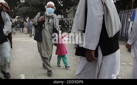 NO FILM, NO VIDEO, NO TV, NO DOCUMENTARY - A man and child wear surgical face masks while walking through the central city marketplace in Kabul, Afghanistan on Saturday, November 7, 2009. The government has declared a state of emergency, and closed schools, universities and even wedding halls and public bathrooms for three weeks to slow the spread of the virus, which has killed 10 people in the capital in less than two weeks. Photo by Chuck Liddy/Raleigh News & Observer/MCT/ABACAPRESS.COM Stock Photo