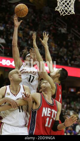 NO FILM, NO VIDEO, NO TV, NO DOCUMENTARY - Cleveland Cavaliers' Anderson Varejao (17) shoots with help from teammage Zydrunas Ilgauskas against the defensive pressive from New Jersey Nets' Brook Lopez (11) and Yi Jianlian during NBA Basketball match, New Jersey Nets vs Cleveland Cavaliers at the Quicken Loans Arena in Cleveland, USA on Februrary 9, 2010. Cleveland won 104-97. Photo by Paul Tople/MCT/ABACAPRESS.COM Stock Photo