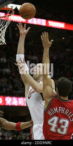 NO FILM, NO VIDEO, NO TV, NO DOCUMENTARY - Cleveland Cavaliers' Zydrunas Ilgauskas shoots over New Jersey Nets' Kris Humphries during NBA Basketball match, New Jersey Nets vs Cleveland Cavaliers at the Quicken Loans Arena in Cleveland, USA on Februrary 9, 2010. Cleveland won 104-97. Photo by Paul Tople/MCT/ABACAPRESS.COM Stock Photo