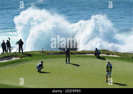 NO FILM, NO VIDEO, NO TV, NO DOCUMENTARY - Waves crash against the rocks as Dustin Johnson putts on the seventh green during the AT&T Pebble Beach National Pro-Am, Final Round in Pebble Beach, in California, USA on February 14, 2010. Photo by Jose Carlos Fajardo/MCT/Cameleon/ABACAPRESS.COM Stock Photo