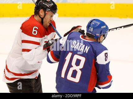 Canada's Shea Weber runs into Slovakia's Miroslav Satan during the third  period of their semifinal game at Canada Hockey Place in Vancouver, Canada,  during the 2010 Winter Olympics on February 26, 2010.