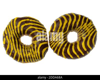 Two American donuts covered with chocolate and with yellow stripes on a white background Stock Photo