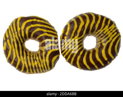 Two American donuts covered with chocolate and with yellow stripes on a white background Stock Photo