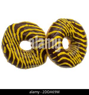 Two American donuts covered with chocolate and with yellow stripes on a white background Stock Photo