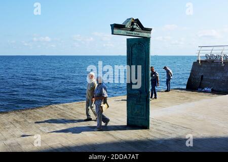 ODESA, UKRAINE - SEPTEMBER 25: The couple of senior people with medical masks are near the House of the Sun art object. It  is located on the Lanzhero Stock Photo