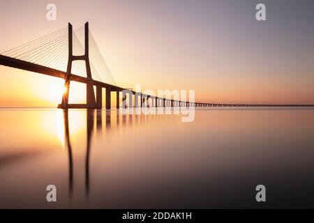 Portugal, Lisbon District, Lisbon, Vasco da Gama Bridge at sunset Stock Photo