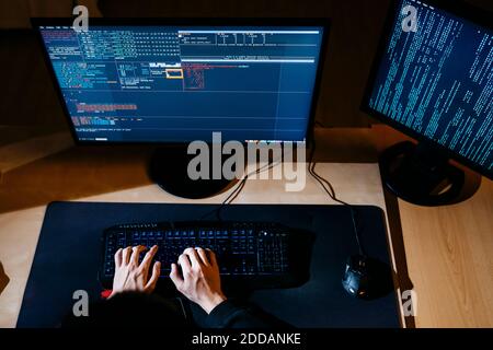 Hacker hands working on computer at office Stock Photo