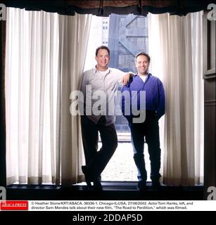 NO FILM, NO VIDEO, NO TV, NO DOCUMENTARY - © Heather Stone/KRT/ABACA. 36336-1. Chicago-IL-USA, 27/06/2002. Actor Tom Hanks, left, and director Sam Mendes talk about their new film, The Road to Perdition, which was filmed. Stock Photo